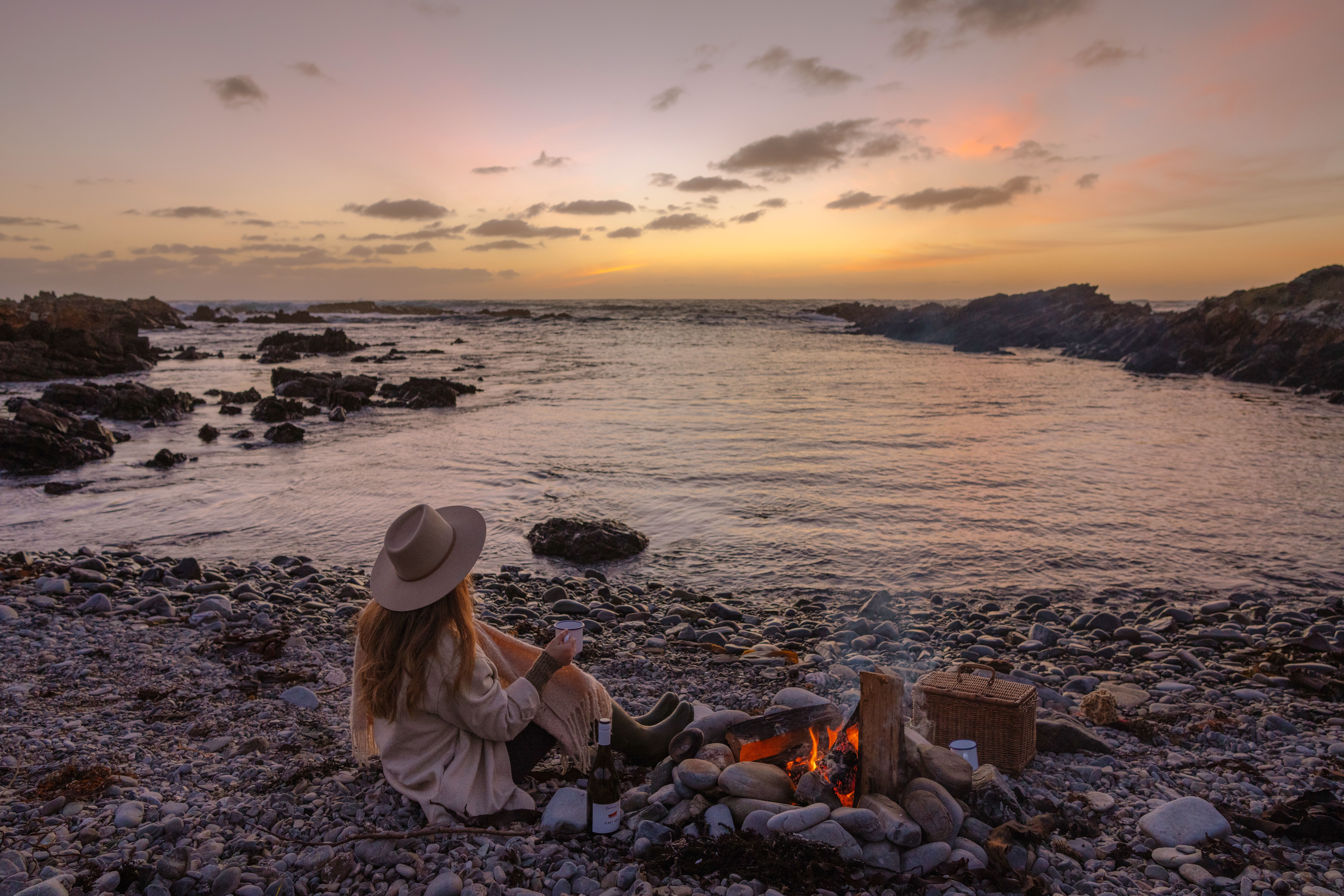 A person on a beach beside a campfire on King Island, Tasmania