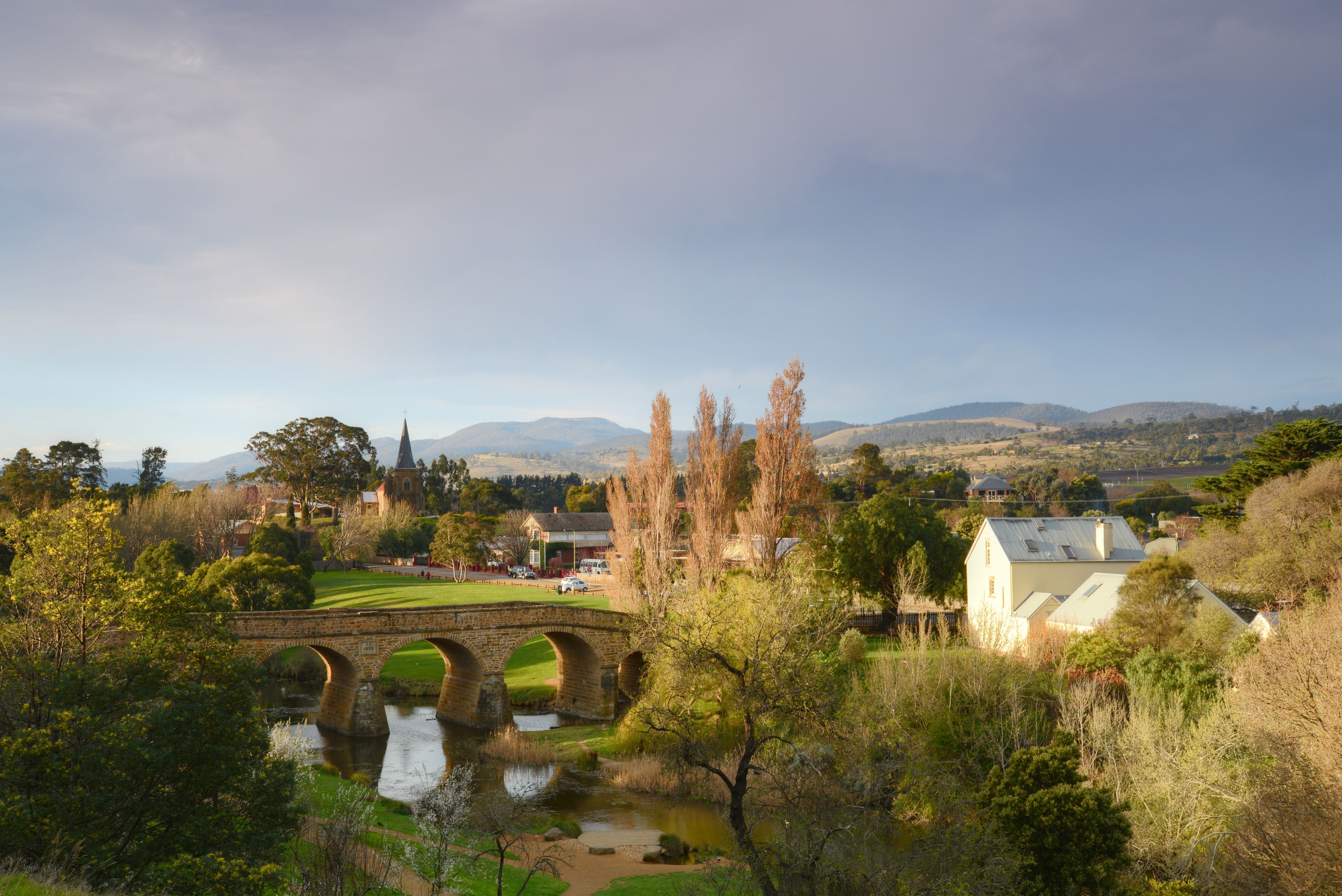 Richmond Bridge over the Coal River with church spire and colonial-era town beyond, Richmond, Tasmania