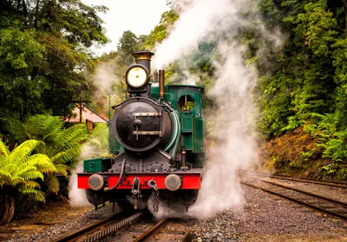 A green steam train on the West Coast Wilderness Railway between Queenstown and Strahan, Tasmania