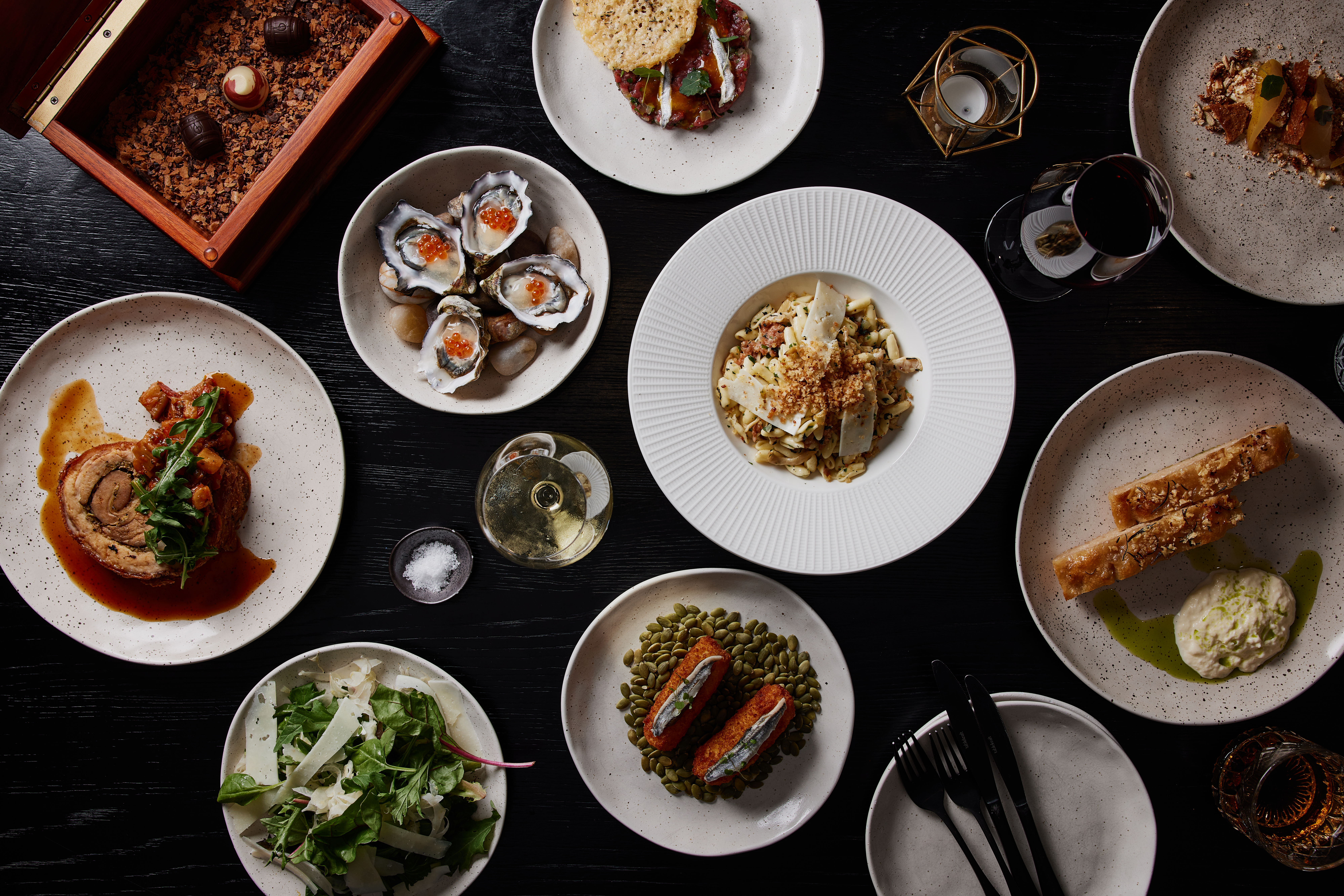 Overhead view of shared plates of food on a table