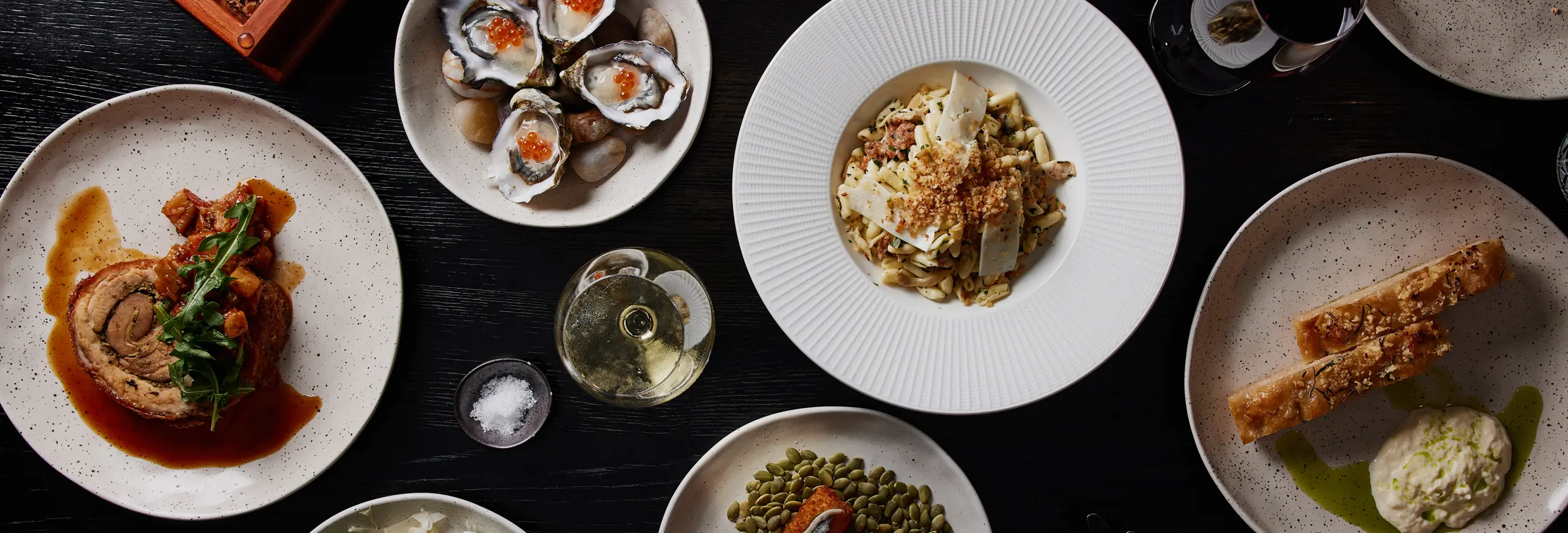 Overhead view of shared plates of food on a table