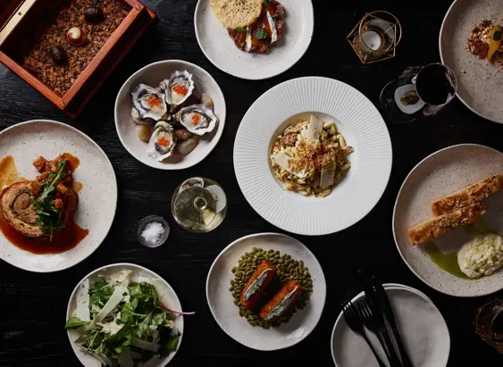Overhead view of shared plates of food on a table