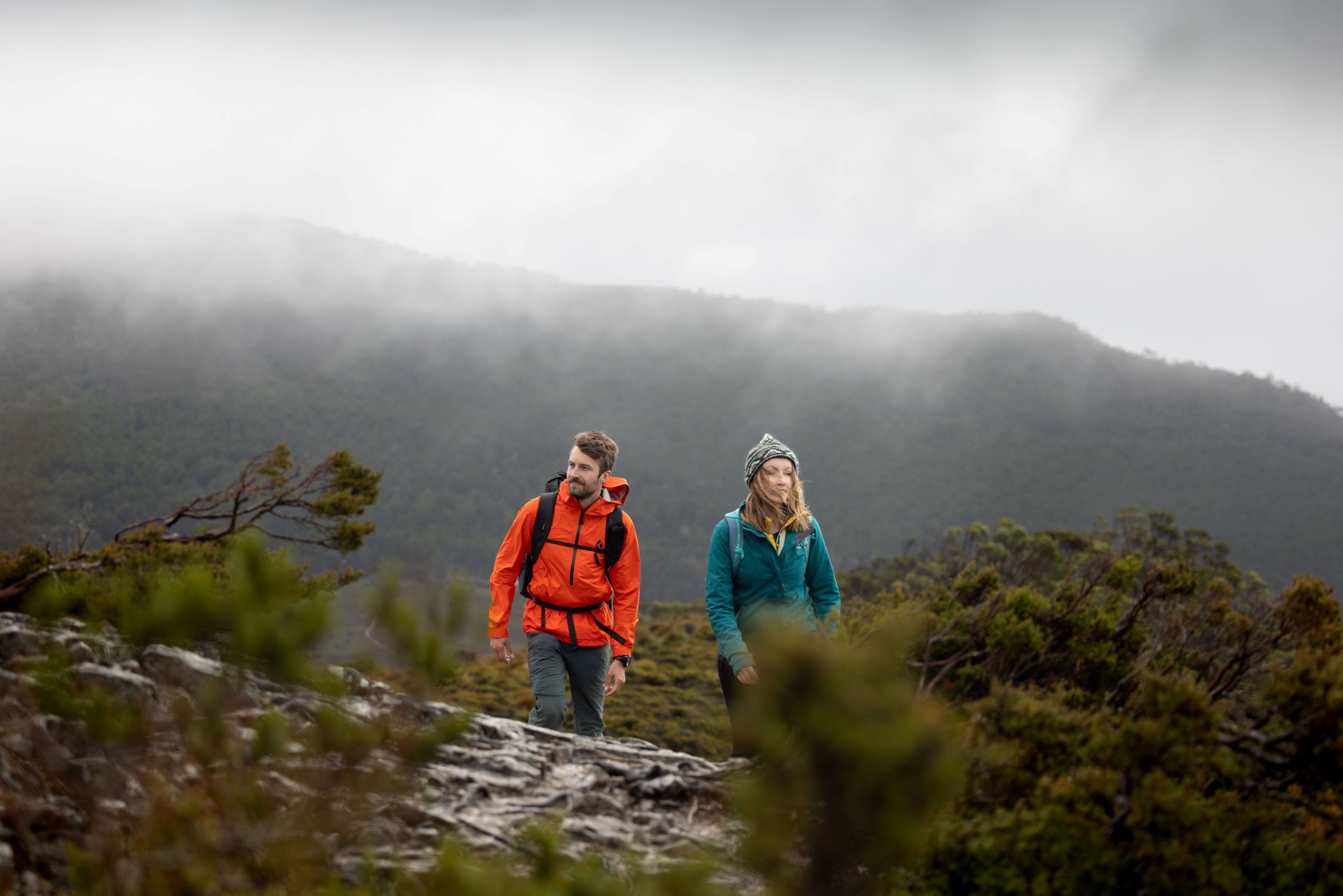 Man and women hiking through the Tasmanian wilderness