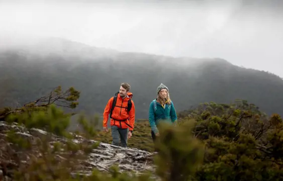 Man and women hiking through the Tasmanian wilderness