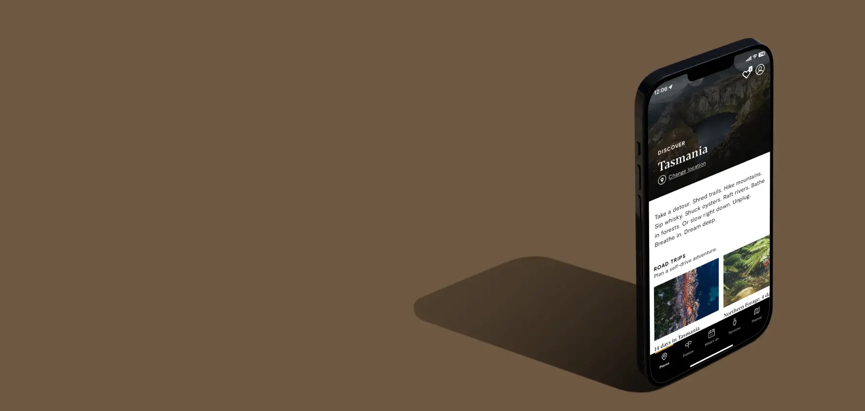 A mobile phone with the screen displaying the Discover Tasmania app